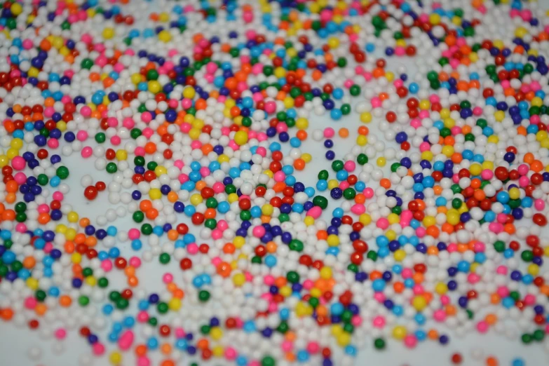 a white plate topped with lots of colorful sprinkles, pexels, pointillism, high resolution macro photo, full of colour 8-w 1024, beads of sweat, sea of parfait
