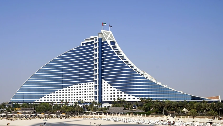 a large building sitting on top of a sandy beach, by Edmund Greacen, pixabay, dubai, blue whale, hotel room, verner panton