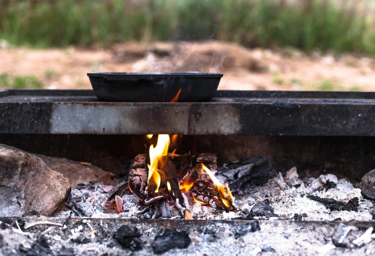 a pot sitting on top of an open fire, by Dietmar Damerau, shutterstock, “ iron bark, cooking pizza, outdoor photo, morning detail