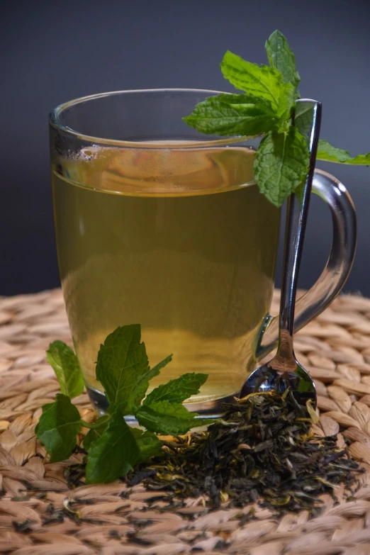 a cup of green tea with a sprig of mint, by Dietmar Damerau, pexels, hurufiyya, stock photo, floating detailes, straw, highly polished