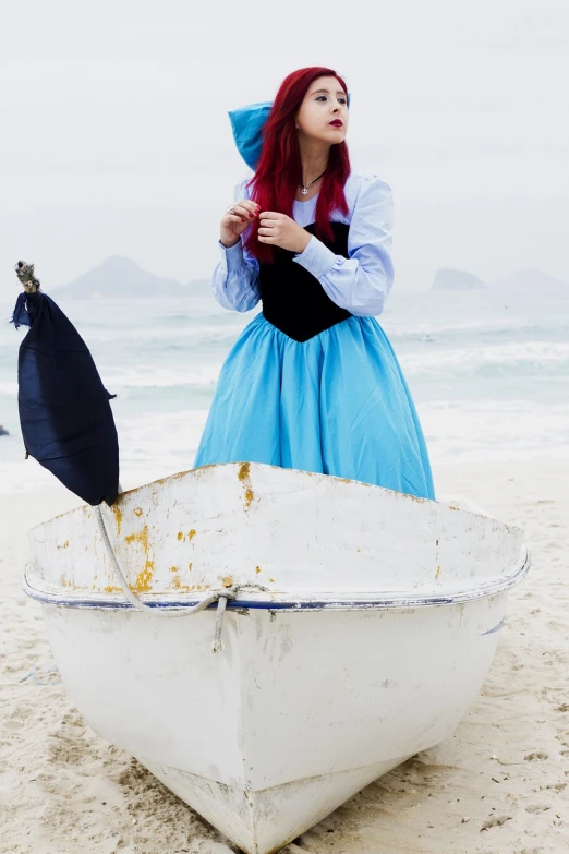 a woman in a blue dress is sitting in a boat on the beach, a photo, inspired by Antônio Parreiras, tumblr, conceptual art, cosplay of a catboy! maid! dress, with long red hair, mary poppins, with a whitish