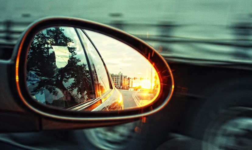 a rear view mirror on the side of a car, by Alexander Bogen, flickr, happening, golden hour”, tilt shift”, view from the side”, ((fish eye))