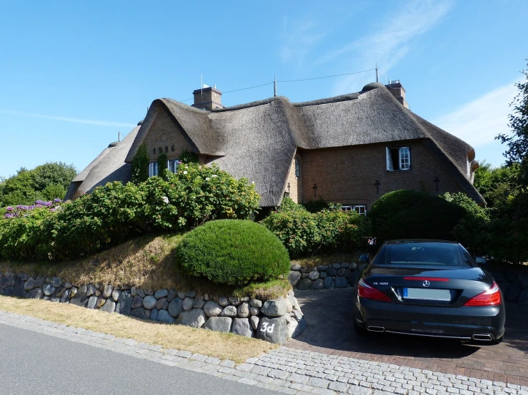 a car parked in front of a house with a thatched roof, by Ladrönn, maintenance photo, view from the distance, photo taken in 2018, very very high detailed