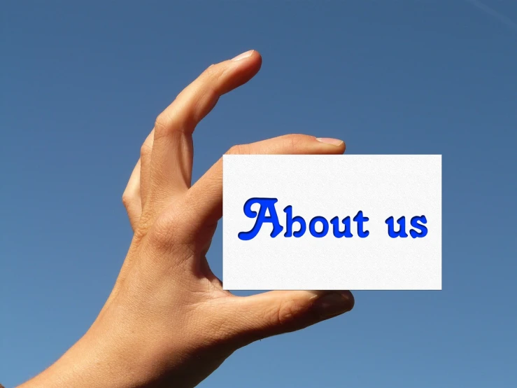 a person holding a piece of paper with the word about us written on it, a picture, by Jan Rustem, pixabay, sky view, advert logo, band, 2 0 1 0 photo