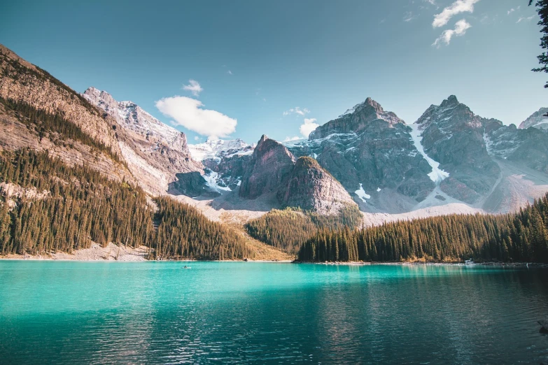 a large body of water with mountains in the background, a tilt shift photo, canada, beatiful backgrounds, turquoise blue face, high res 8k