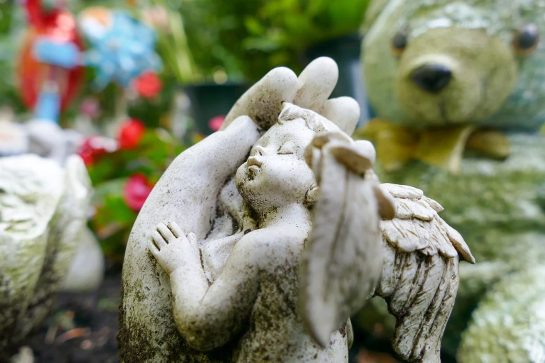 a statue of an angel holding a baby bear, a statue, visual art, paradise garden massage, closeup photo, mid shot photo, many years gone