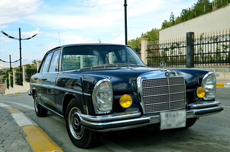 a black car parked on the side of the road, a portrait, by Alejandro Obregón, pixabay, mercedez benz, vintage - w 1 0 2 4, very symmetrical body, jamaica