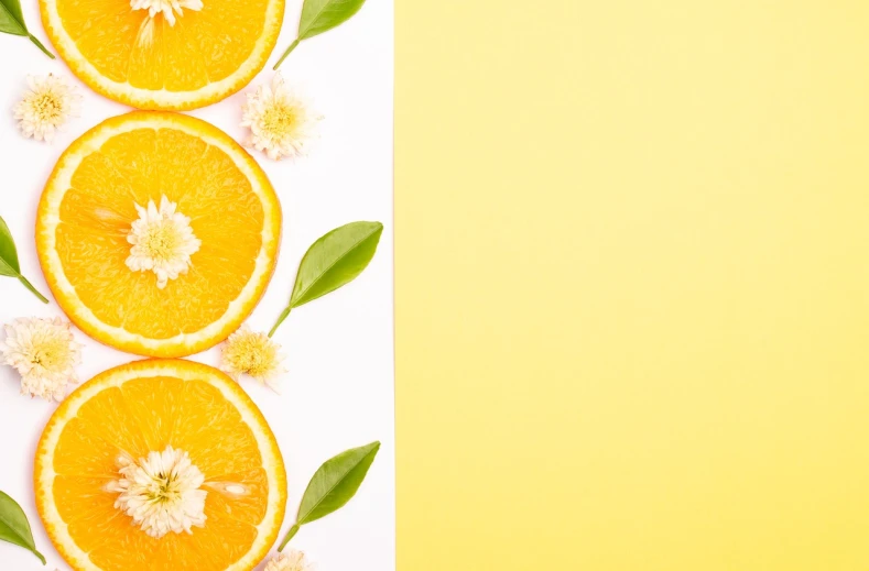 orange slices with leaves and flowers on a yellow background, pexels, minimalism, background image, on white paper, perfume, half image