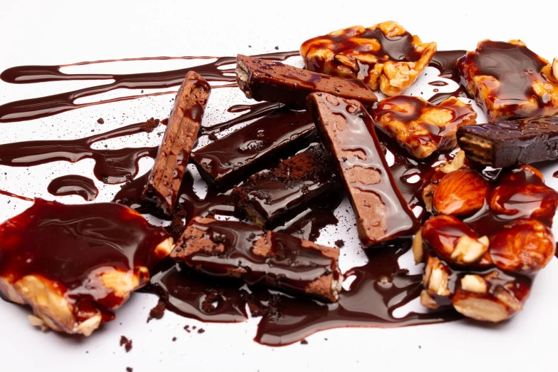 a plate that has some kind of dessert on it, antipodeans, smothered in melted chocolate, brittle. highly detailed, istock, close up food photography