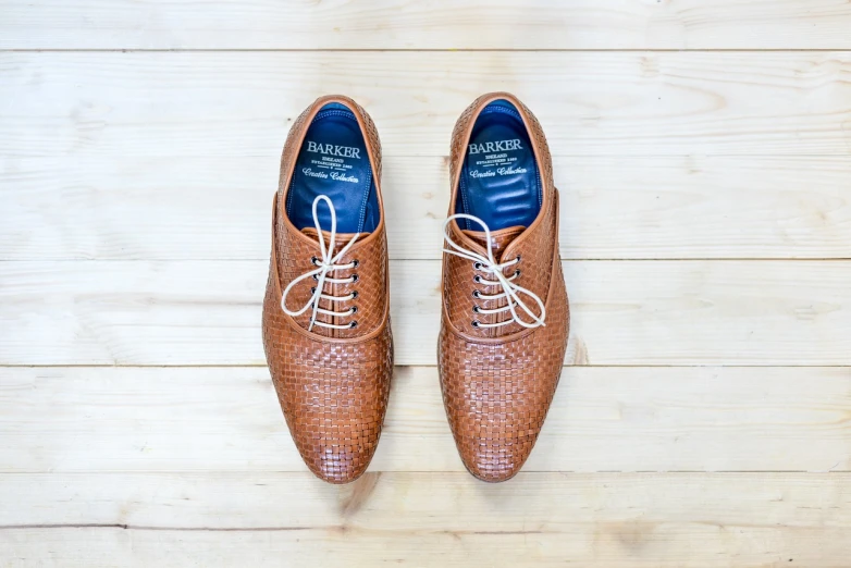 a pair of brown shoes sitting on top of a wooden floor, a picture, by Romain brook, shutterstock, highly detailed product photo, flat lay, bamboo, modern very sharp photo