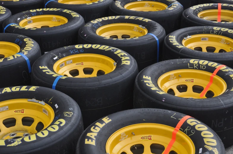 a pile of tires sitting next to each other, by Paul Emmert, flickr, nascar, vertical wallpaper, hq ”, chocolate