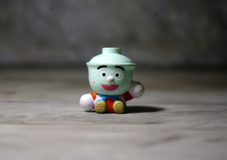 a close up of a toy on a table, a picture, inspired by Jim Davis, unsplash, mingei, the god of propane, south east asian with round face, little kid, hong soonsang