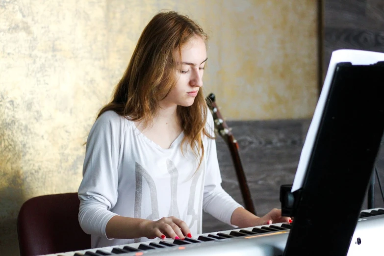 a woman that is sitting in front of a keyboard, by Anna Haifisch, teen girl, practice, with backdrop of natural light, vladimir krisetskiy