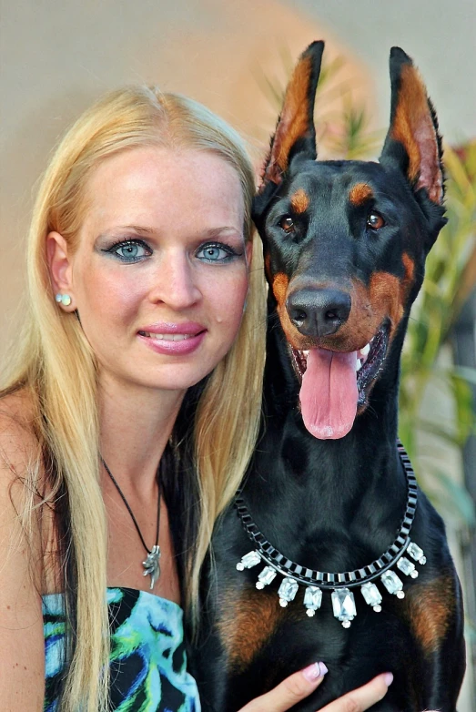 a close up of a person holding a dog, a portrait, by Eva Švankmajerová, pixabay, very long neck, swarovski, attractive girl, portrait big dark dog