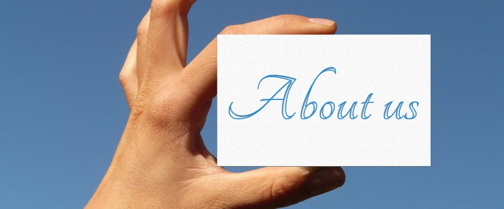 a hand holding a piece of paper with the word about us written on it, a picture, trending on pixabay, sky view, business card, adrien girod, high detail of a hand