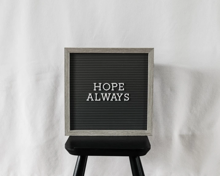 a black and white photo of a sign that says hope always, pexels, minimalism, 🤬 🤮 💕 🎀, stock photo, 1 6 x 1 6, easel