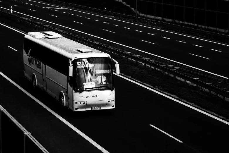 a black and white photo of a bus on a highway, a black and white photo, by Matthias Weischer, flickr explore 5 0 mm, krzysztof kononowicz, edited in photoshop, modern high sharpness photo