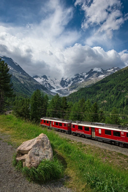a red train traveling through a lush green forest, by Werner Andermatt, shutterstock, icy glaciers, with mountains in background, 🕹️ 😎 🔫 🤖 🚬, glacier photography