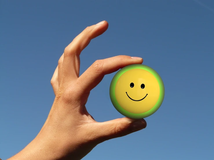 a person holding a smiley face ball in their hand, a picture, by Jan Rustem, precisionism, cad, very very happy!, a green, everyday plain object