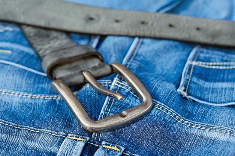 a close up of a belt on a pair of jeans, a stock photo, by Frederik Vermehren, happening, istockphoto, blue and silver colors, packshot, utilitarian