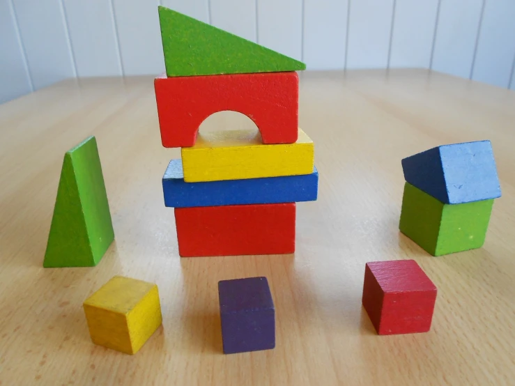 a pile of wooden blocks sitting on top of a wooden table, inspired by Josef Block, flickr, primary colours, taken from the high street, simple structure, bauhause