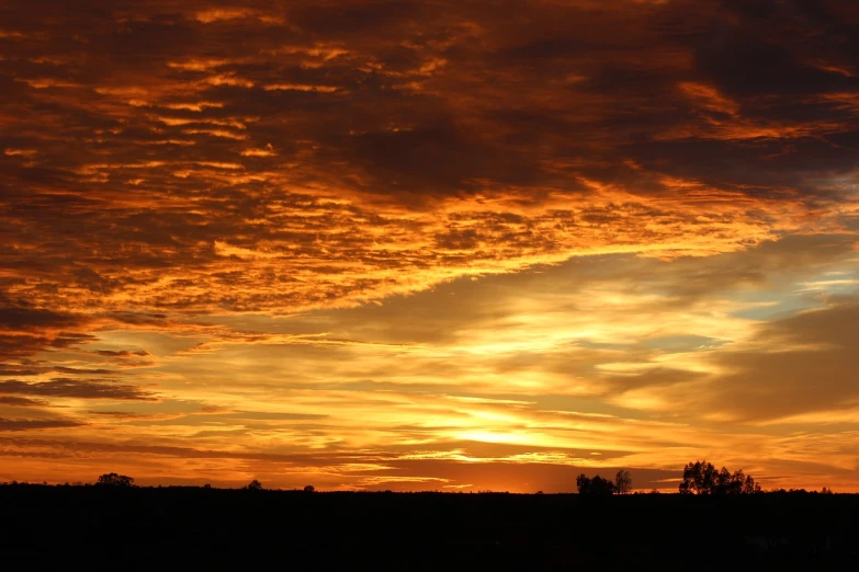 a person is flying a kite at sunset, by Linda Sutton, flickr, romanticism, sunset panorama, arizona, orange dawn, layered stratocumulus clouds