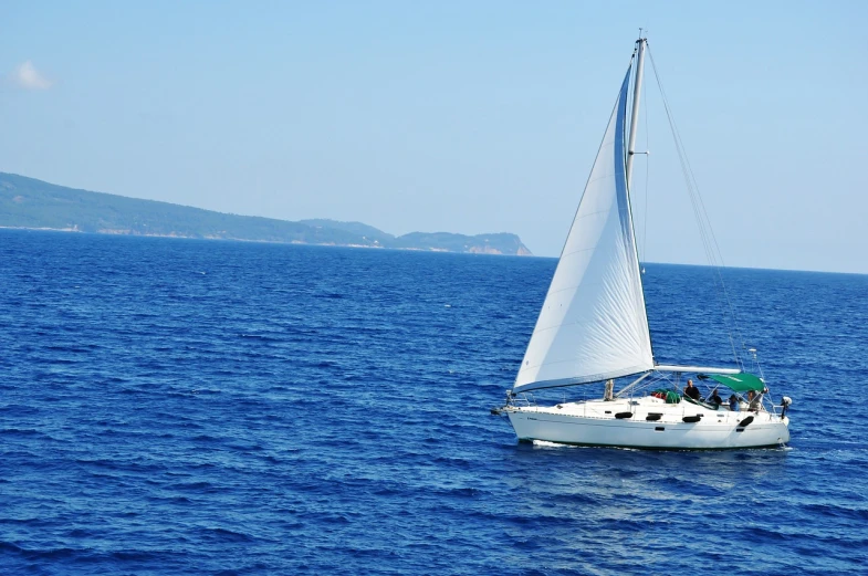 a sailboat in the middle of a large body of water, a picture, by John Murdoch, shutterstock, right side composition, white and blue, romantic, on a bright day