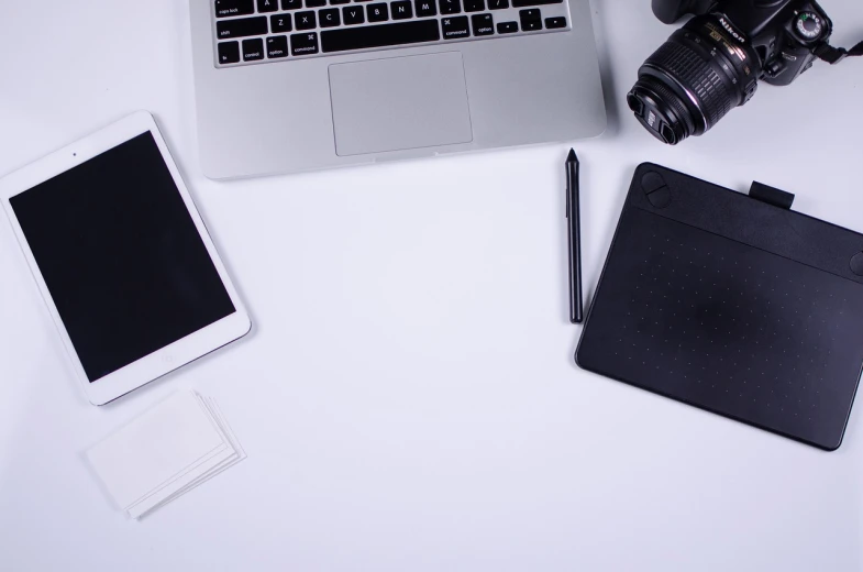 an open laptop computer sitting on top of a white desk, a picture, pexels, computer art, draw with wacom tablet, camera photo, white background : 3, devices and instruments