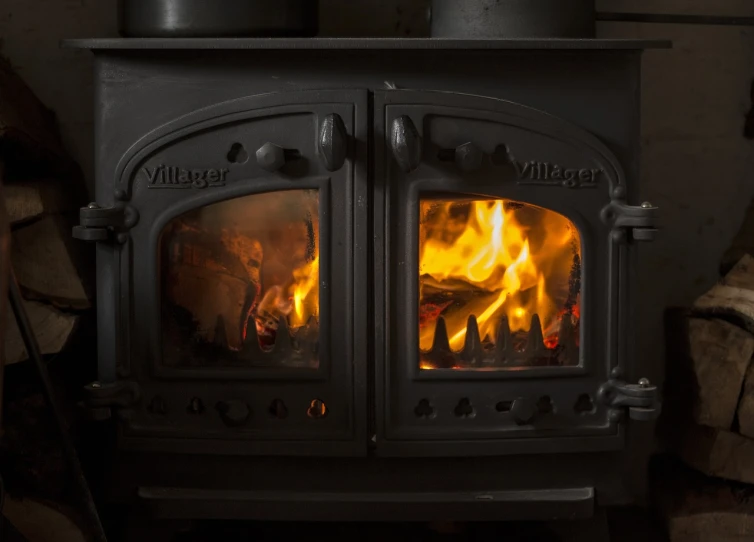 a wood burning stove sitting next to a pile of logs, by John Murdoch, istock, looking into the flames, twins, fire from some windows