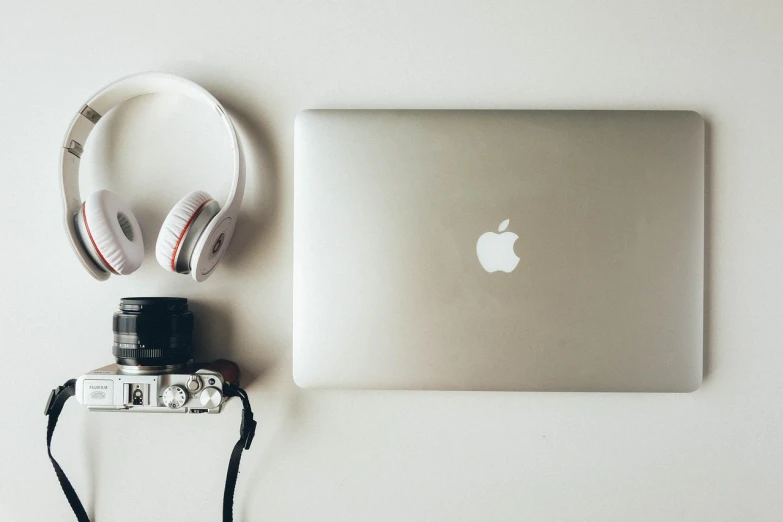 a laptop, headphones and a camera on a table, by Romain brook, minimalism, apple, flickr explore 5 0 mm, 🎨🖌️, headphones dj rave