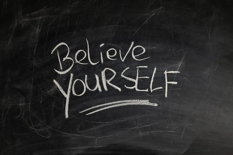 a blackboard with the words believe yourself written on it, a picture, high res photo, very very realistic, realisitc photo