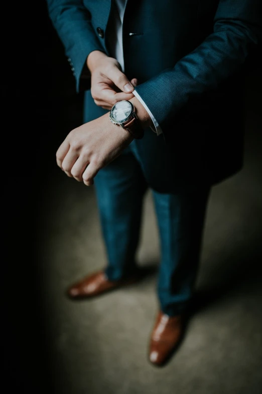 a man in a suit with a watch on his wrist, by Emma Andijewska, unsplash, renaissance, leather shoes, stock photo