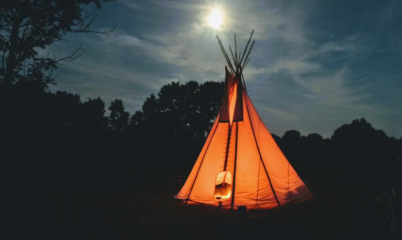 a teepee lit up at night with a full moon in the background, by Robert Lee Eskridge, pexels, land art, big red sun, lit up in a dark room, summer camp, edited