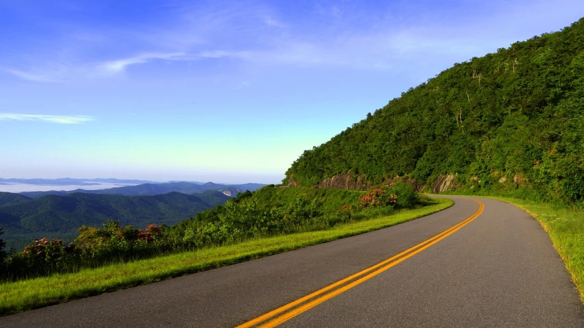 a couple of yellow lines on the side of a road, by Robert Childress, flickr, craggy mountains, stunning vista, summer morning, alabama