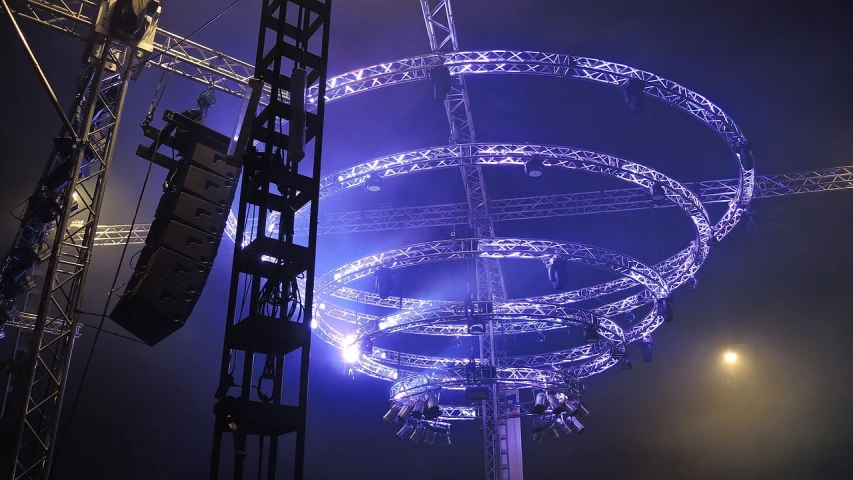 a large circular structure is lit up at night, by Werner Gutzeit, flickr, advanced stage lighting, crane, an ultra realistic, great atmosphere