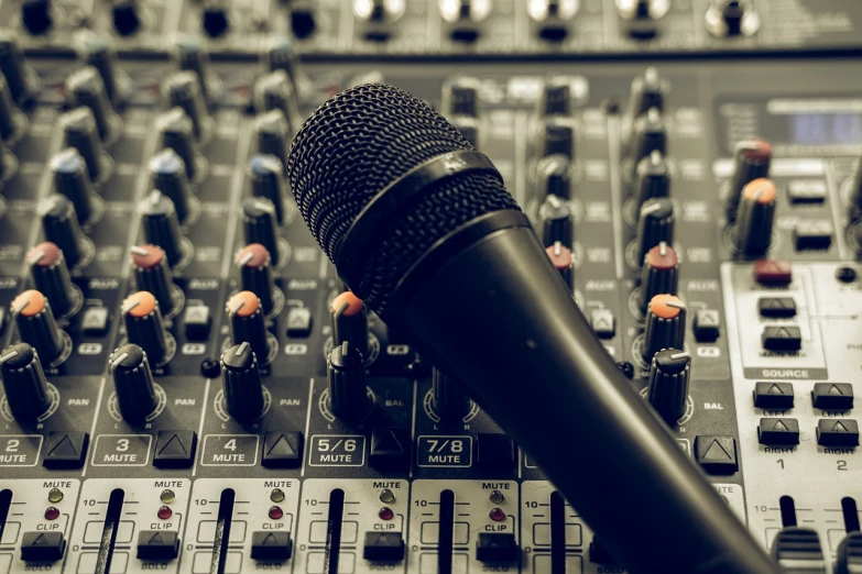 a microphone sitting on top of a sound mixer, shutterstock, close macro photo. studio photo, many speakers, high details photo