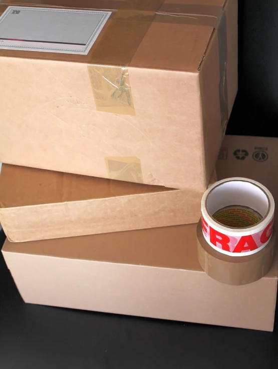 a cup of coffee sitting on top of a stack of boxes, a stock photo, flickr, 40mm tape, plastic wrap, utradetailed, van