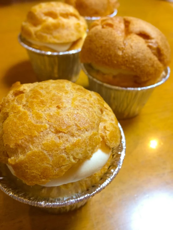 a couple of muffins sitting on top of a table, sōsaku hanga, in style of pan ren wei, shiny!!, traditional corsican, white!!