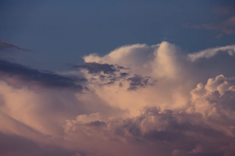 a large jetliner flying through a cloudy sky, a picture, romanticism, storm in the evening, pink cloudy background, cumulus, sunset photo