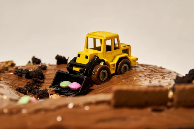 a close up of a cake with a construction vehicle on it, by Dietmar Damerau, figuration libre, high quality upload, everything is made of candy, high resolution product photo, chocolate river