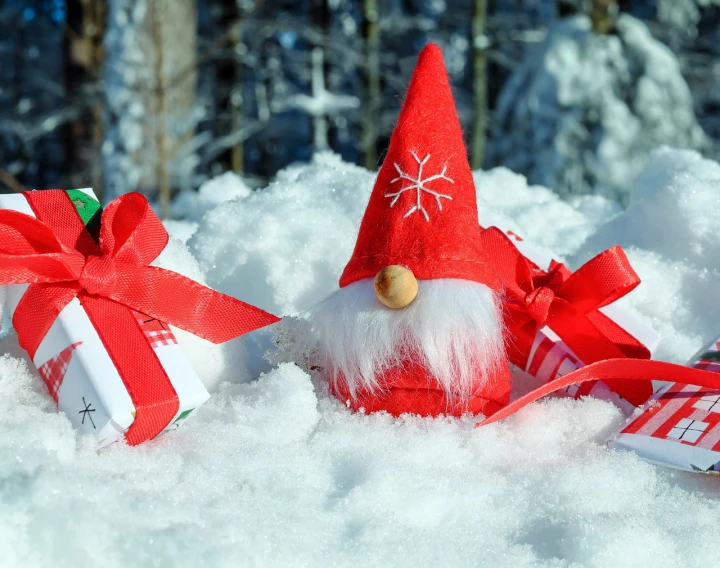 a couple of gnomes sitting on top of a pile of snow, pixabay contest winner, birthday wrapped presents, closeup photo, andrey gordeev, with snow on its peak