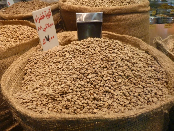 a bunch of bags filled with coffee beans, hurufiyya, damascus, you won't believe it, award - winning crisp details ”, market