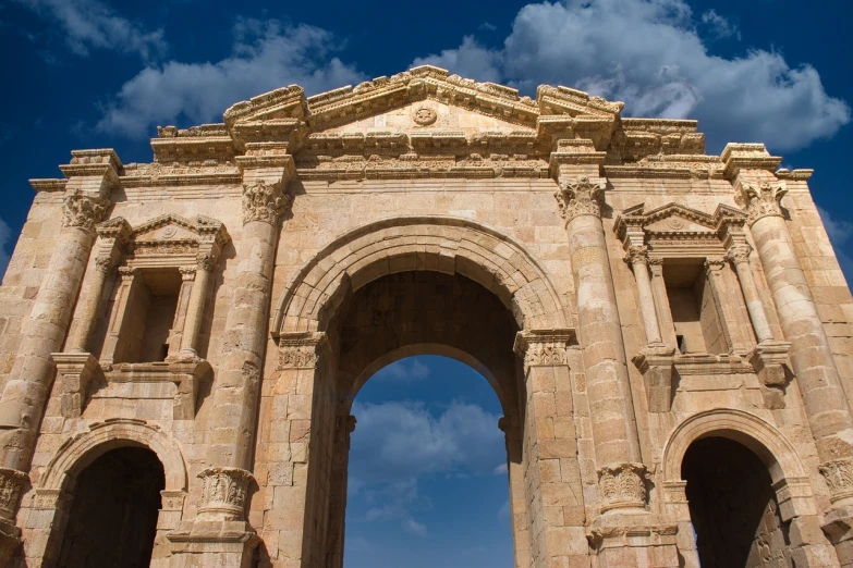 a couple of people that are standing in front of a building, a picture, shutterstock, neoclassicism, massive arch, jordan, huge old ruins, closeup photo