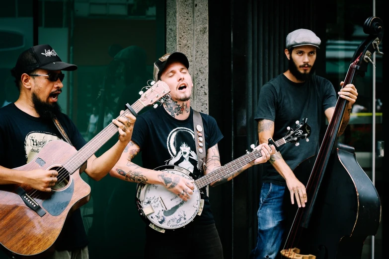 a group of men standing next to each other holding guitars, a portrait, by Alejandro Obregón, unsplash, lowbrow, tattooed man, squinting at high noon, berets, 💣 💥💣 💥