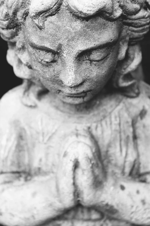 a black and white photo of a statue of an angel, a statue, fine art, praying meditating, close up portrait photo, 3 5 mm photo, child