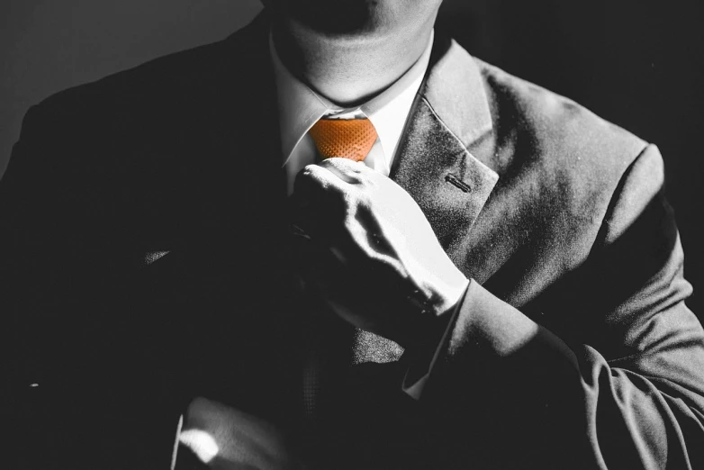 a man in a suit adjusts his tie, pexels, digital art, orange grey white, high-contrast, ready for a meeting, instagram picture