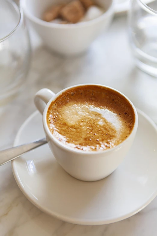 a close up of a cup of coffee on a saucer, pexels, renaissance, photograph credit: ap, 💣 💥, california;, soft natural light