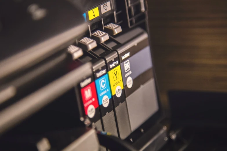 a bunch of ink cartridges sitting on top of a printer, shutterstock, shot on canon eos r 5, bottom angle, stock photo, high quality details