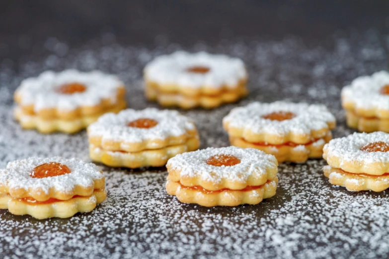 a table topped with cookies covered in powdered sugar, by Dietmar Damerau, shutterstock, baroque, marmalade, 12mm, layered, garis edelweiss