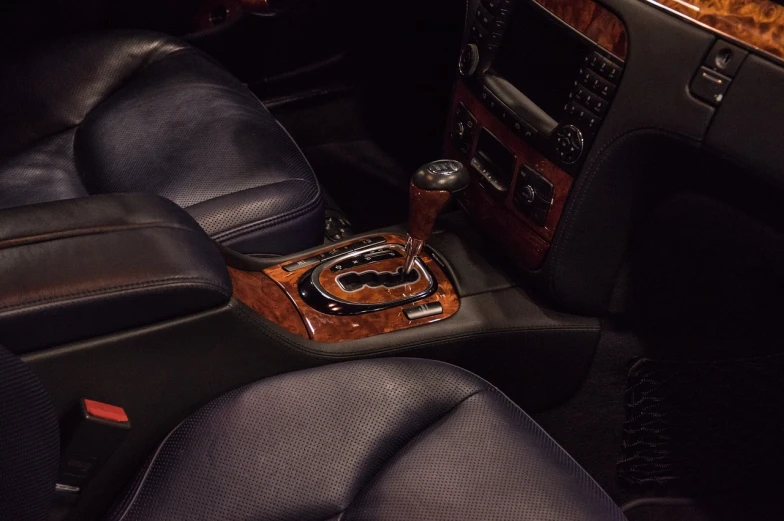 a close up of the center console of a car, a portrait, by Thomas Häfner, auto-destructive art, bentley, wood accents, professionally color graded, taken in the mid 2000s